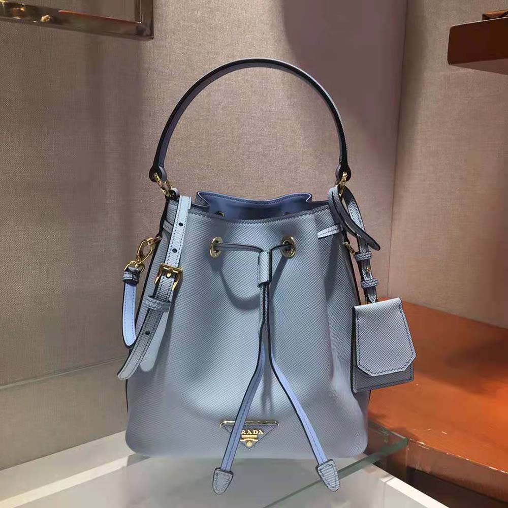 Close-up of blue saffiano leather texture and polished closure on Prada bag