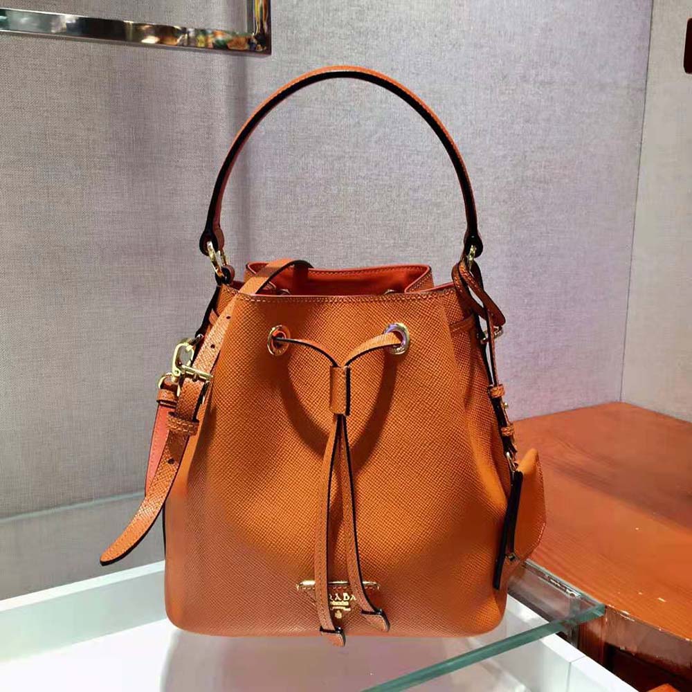 Close-up of vibrant orange Saffiano leather and gold-tone hardware