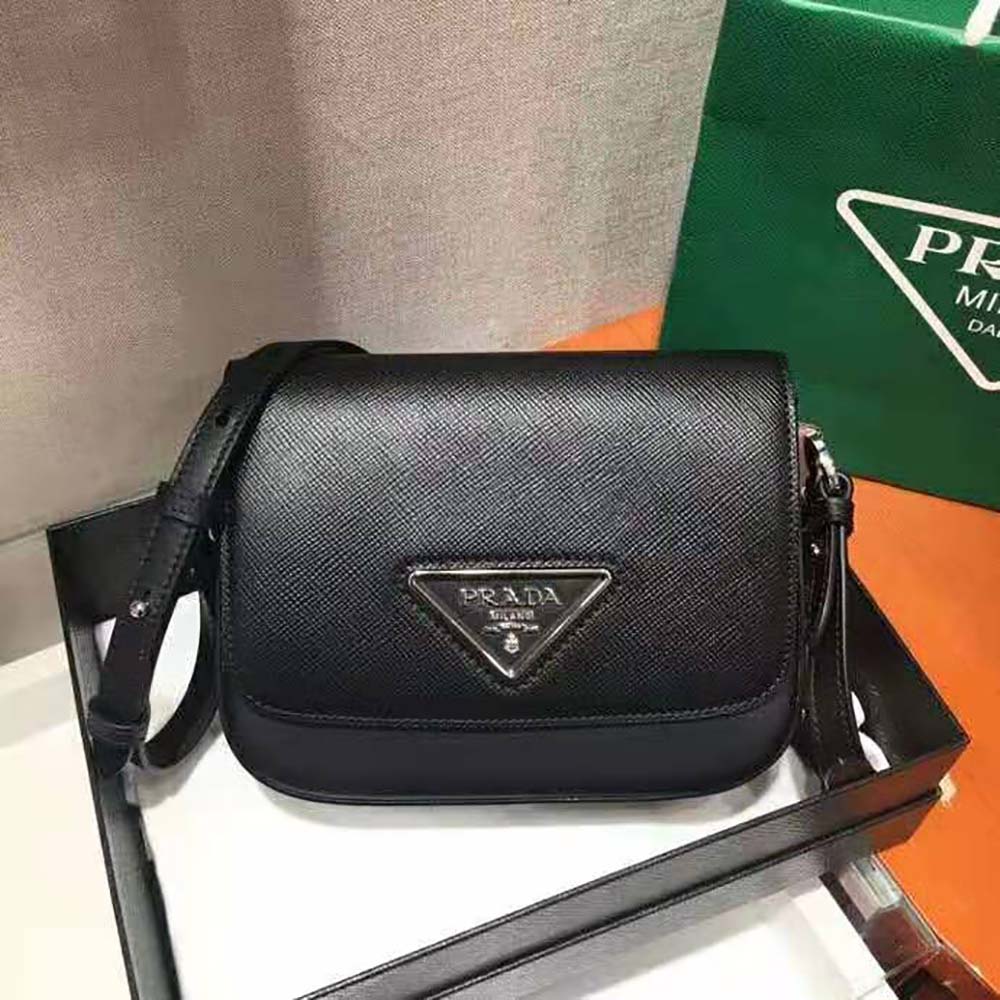 Close-up of gold Prada hardware on black Saffiano leather bag