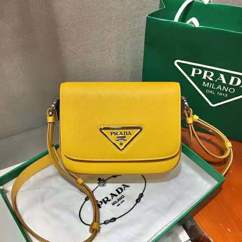 Close-up of yellow saffiano leather and silver Prada logo plaque