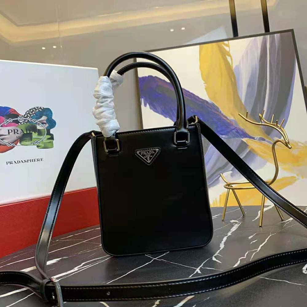 Close-up of brushed leather texture and silver hardware on Prada tote
