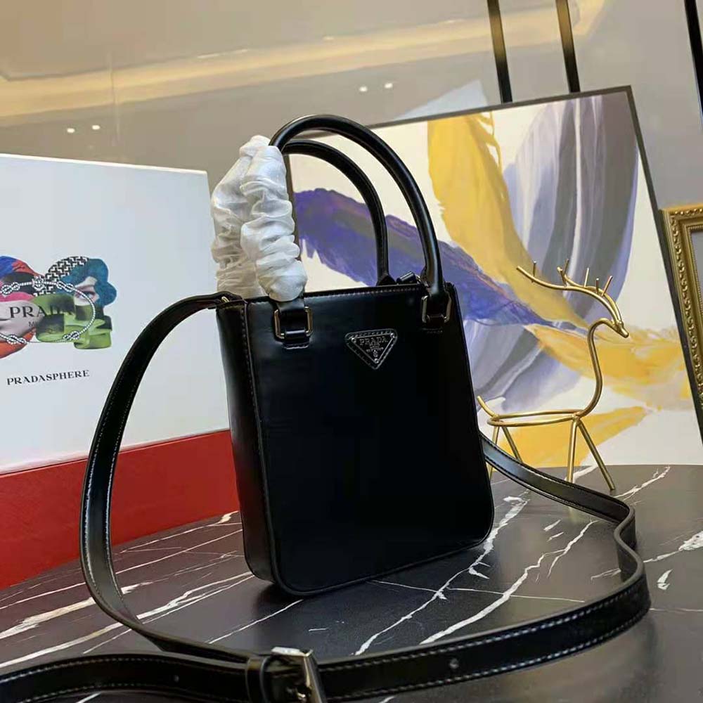 Side angle highlighting slim silhouette of Prada Women Small Brushed Leather Tote-Black