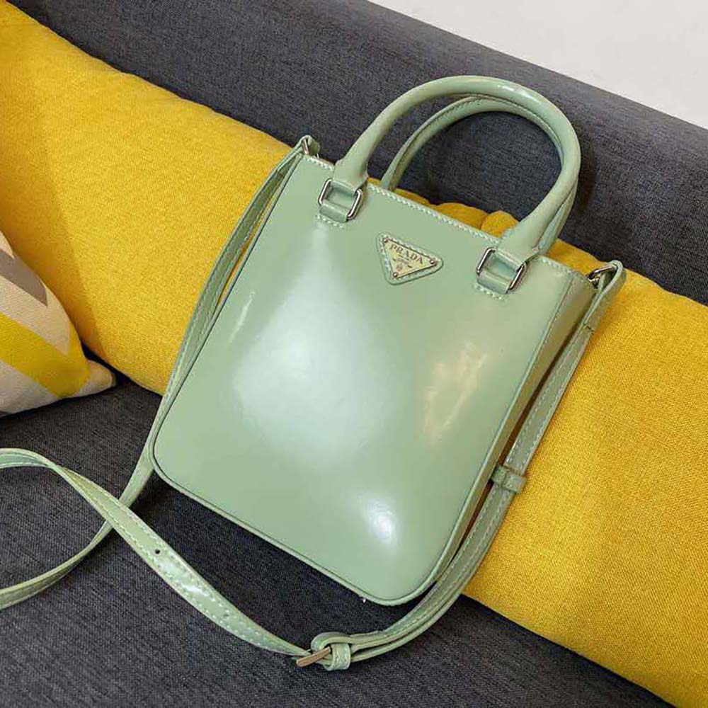 Close-up of silver Prada logo hardware on small brushed leather tote Aqua