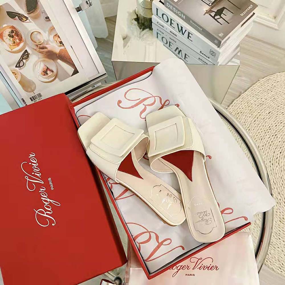 Close-up of covered buckle detail on Roger Vivier white patent leather mules
