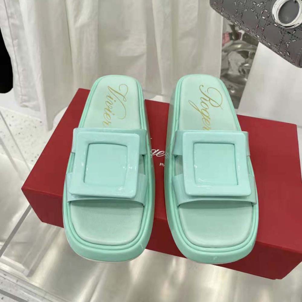 Close-up of aqua patent leather and signature covered buckle detail