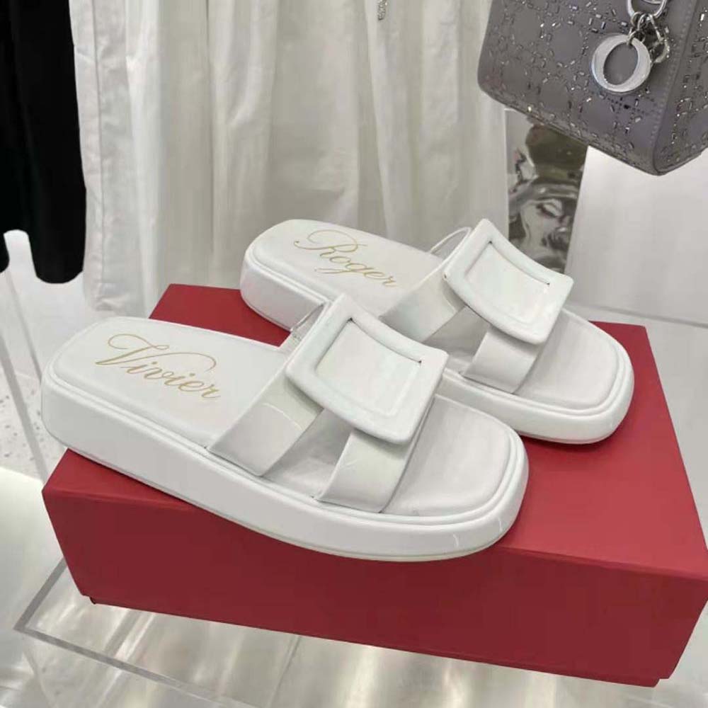 Top-down view showing glossy white patent leather and slide silhouette