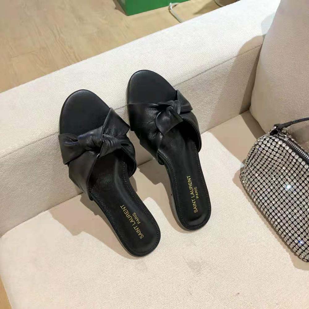 Side angle showing low flat silhouette of Saint Laurent Bianca Mules black