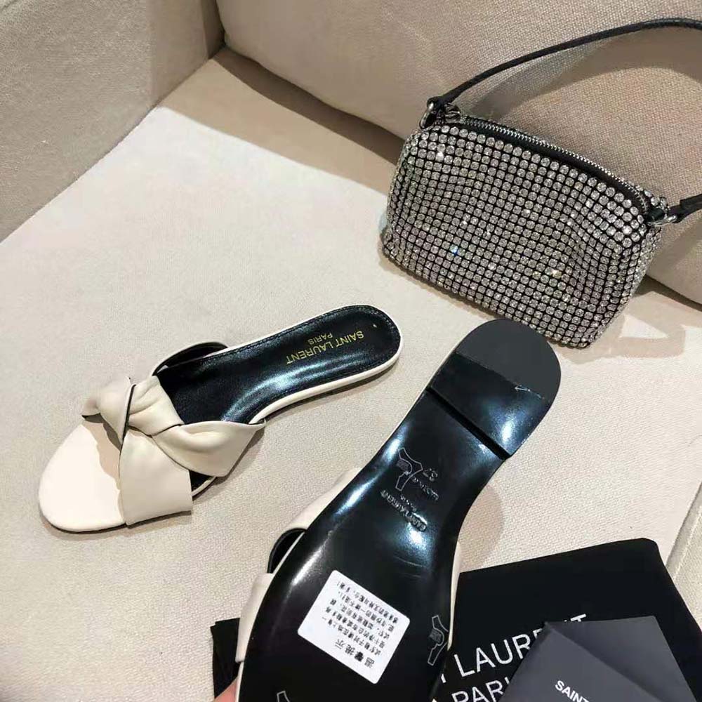 Side view showing sleek silhouette of Saint Laurent YSL Bianca flat mules