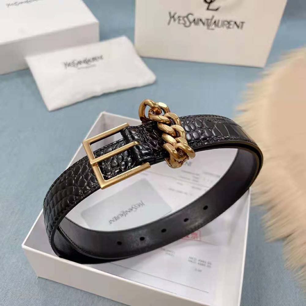 Close-up of silver square buckle and chain-loop detail on Saint Laurent YSL belt