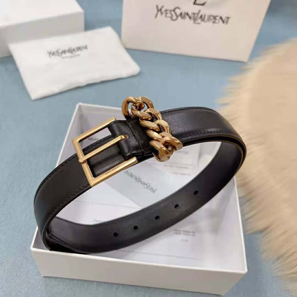 Close-up detail of black suede and square buckle on Saint Laurent YSL belt
