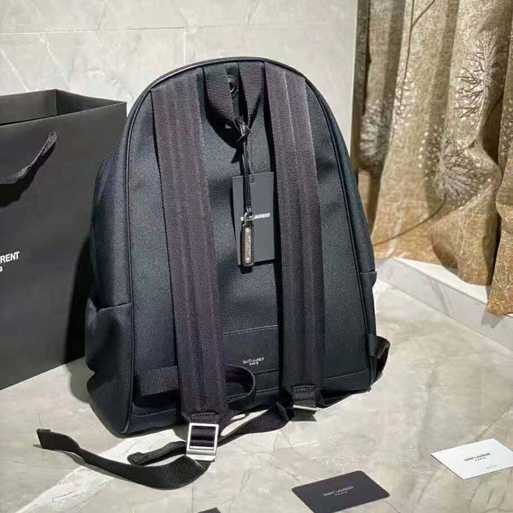 Side angle showing drawstring closure on Saint Laurent City Mini Backpack