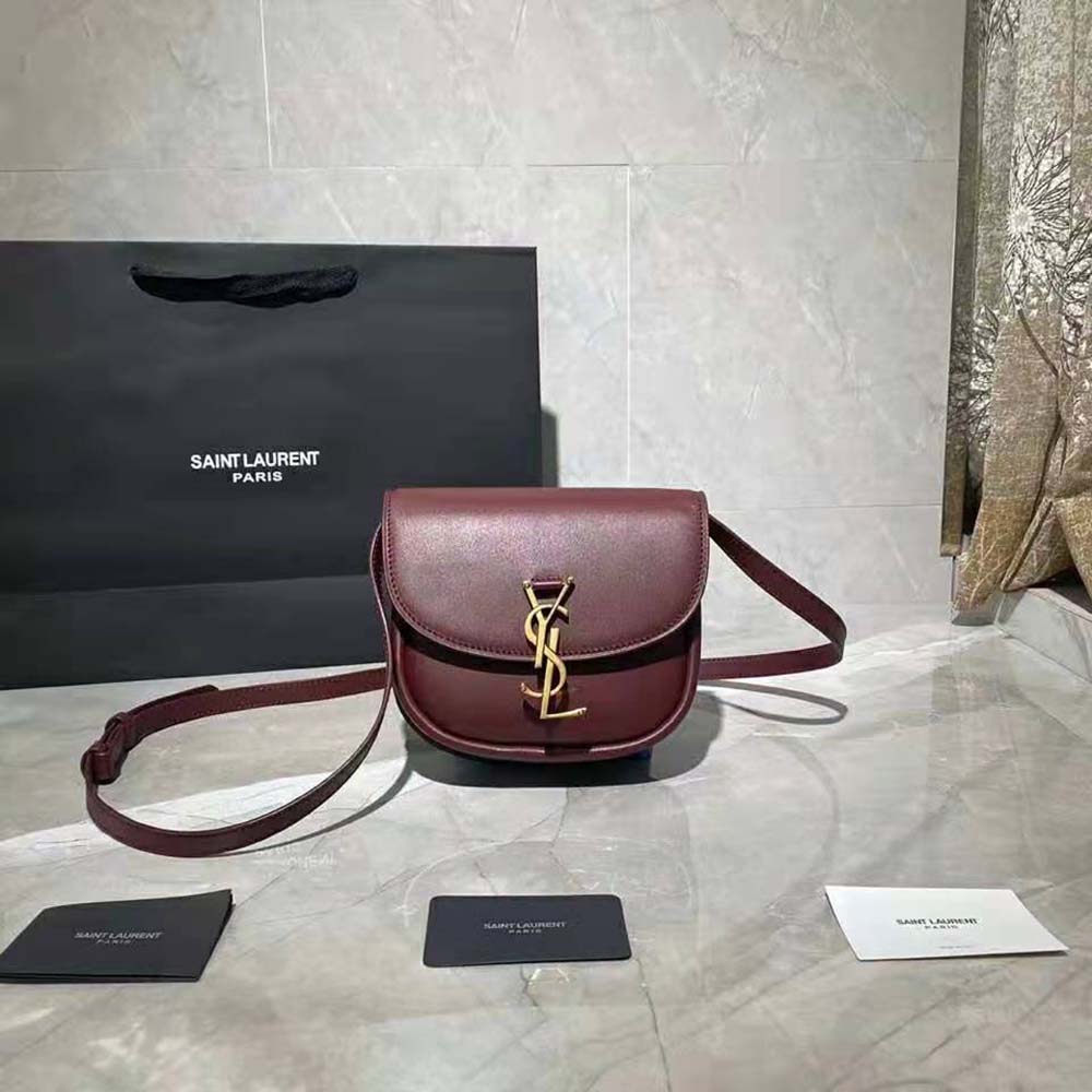 Close-up of gold YSL logo hardware on Kaia Small Satchel smooth leather