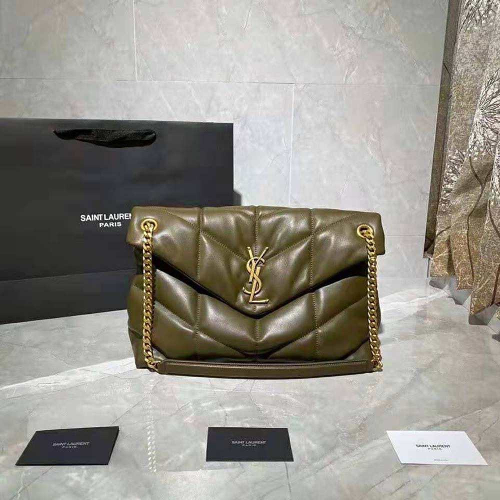Close-up of gold YSL logo hardware on quilted lambskin medium bag