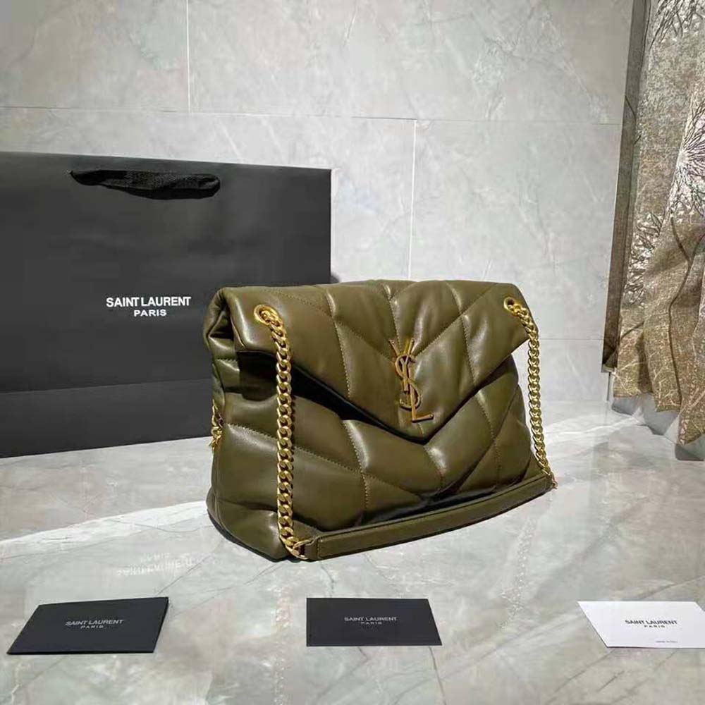 Side angle showing puffer silhouette and flap closure of Saint Laurent YSL bag