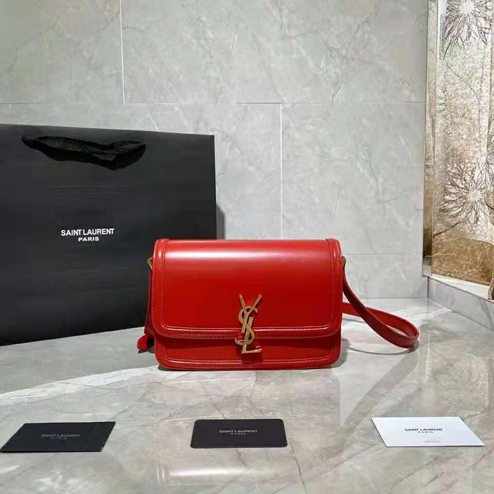 Close-up of gold YSL logo hardware on red Saint Laurent Solferino satchel