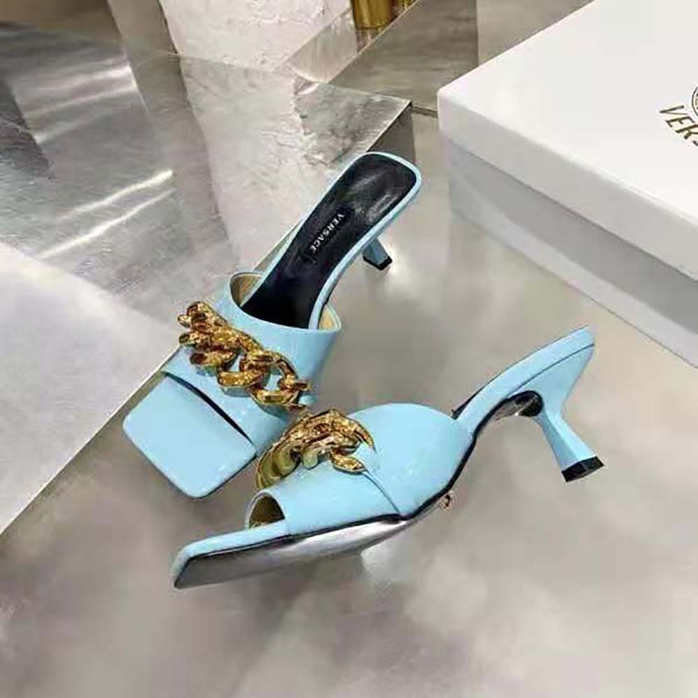 Overhead view of glossy naplak leather on Versace Medusa mules