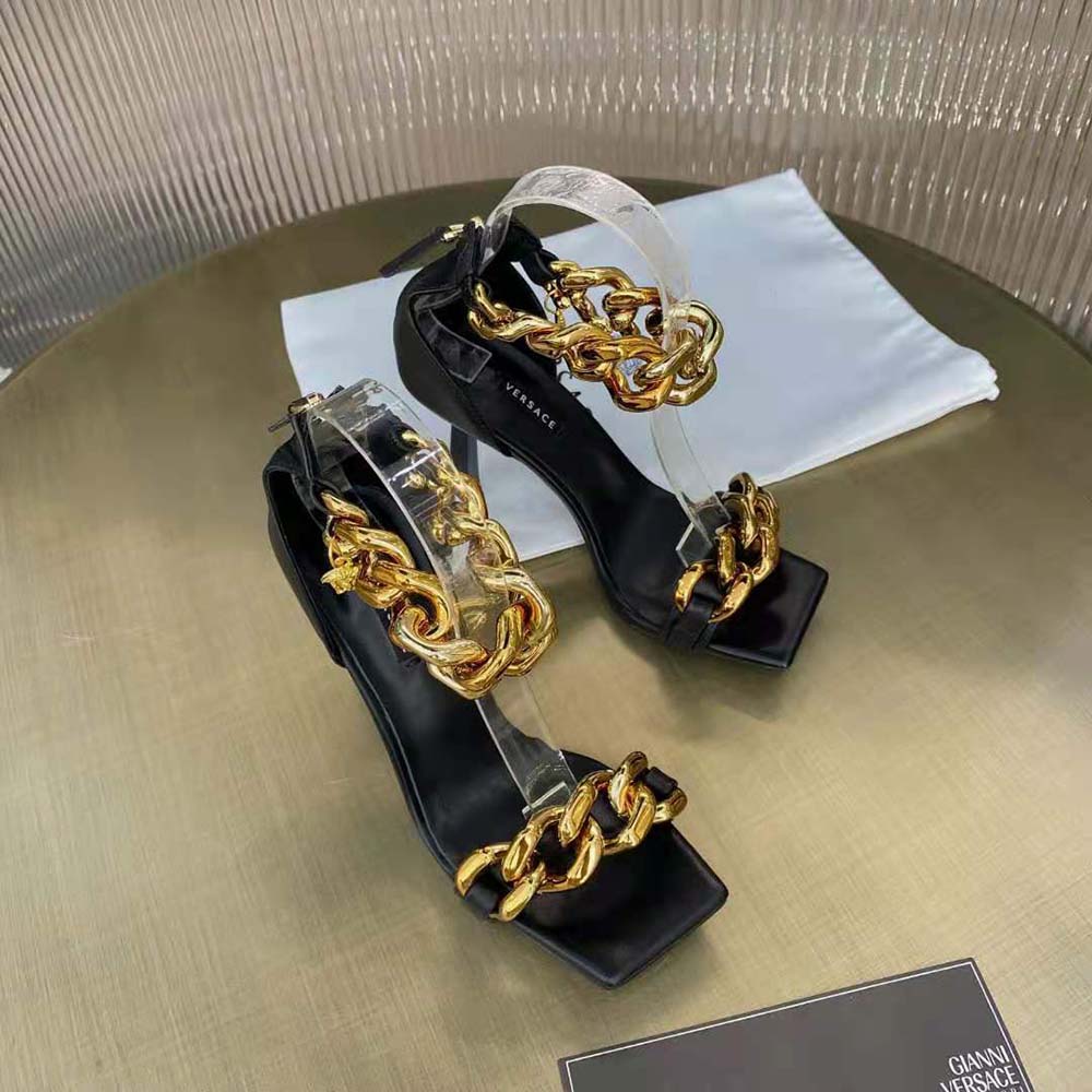 Top view showcasing sleek black nappa leather and stiletto heel on Versace sandals