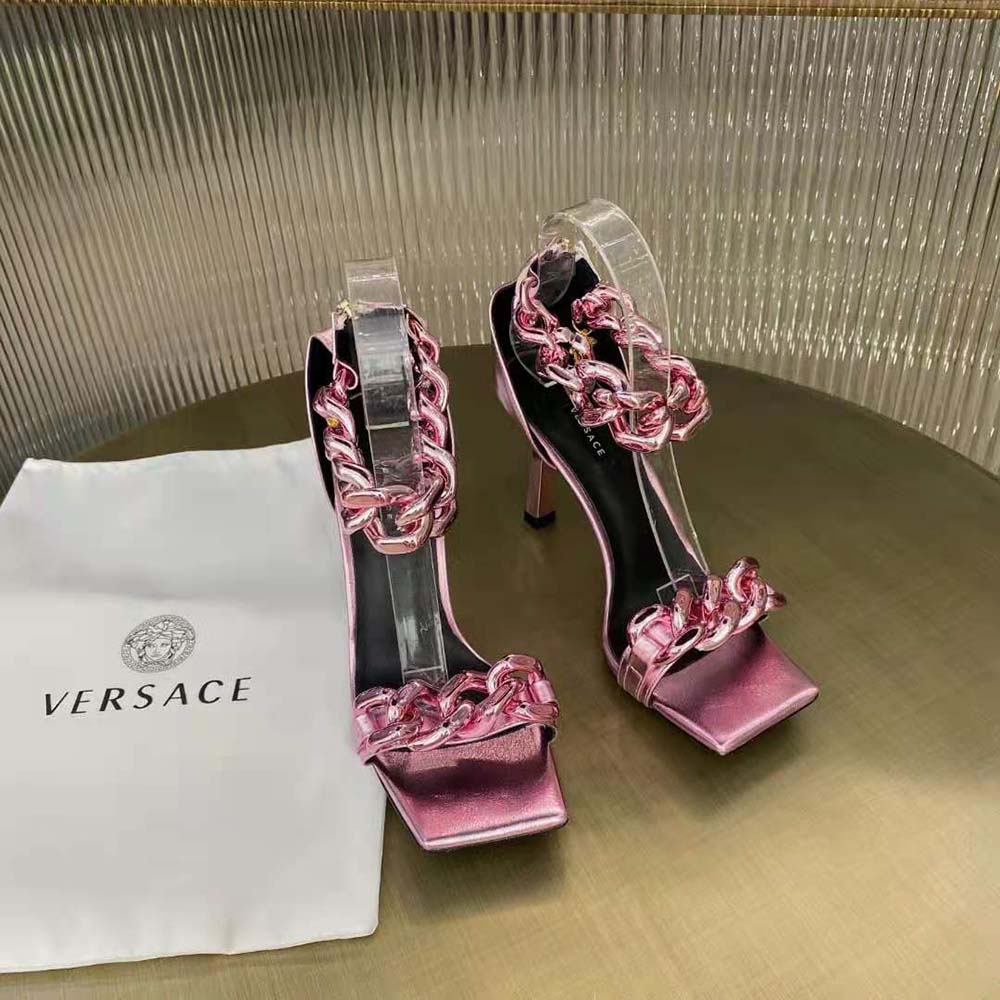Close-up on gold Medusa chain detail of Versace pink suede sandals