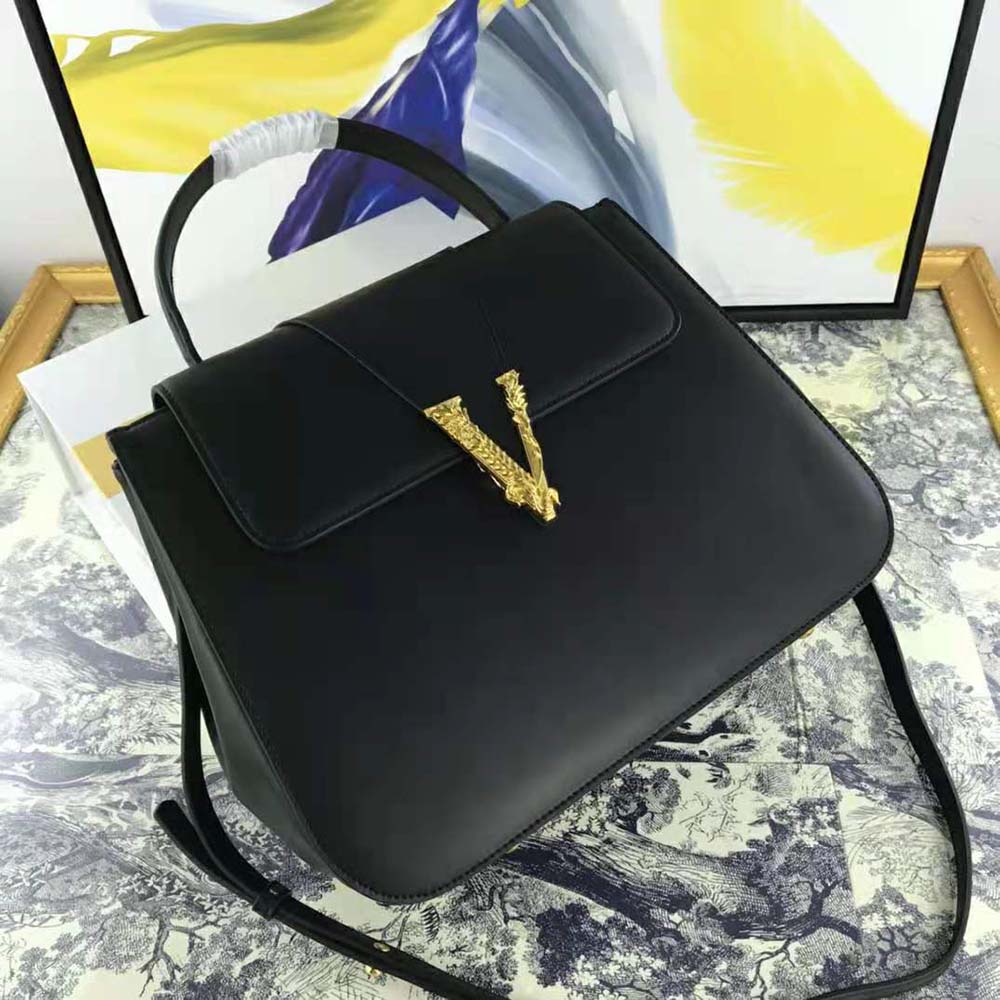 Close-up of gold Medusa hardware on Versace Women Virtus bag