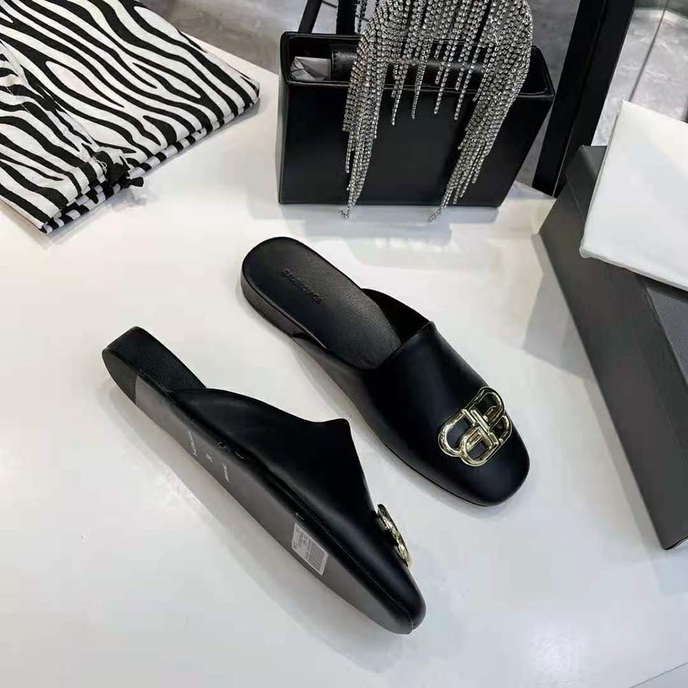 Close-up of aged-gold BB emblem on Balenciaga Women Cosy BB Slide in black leather