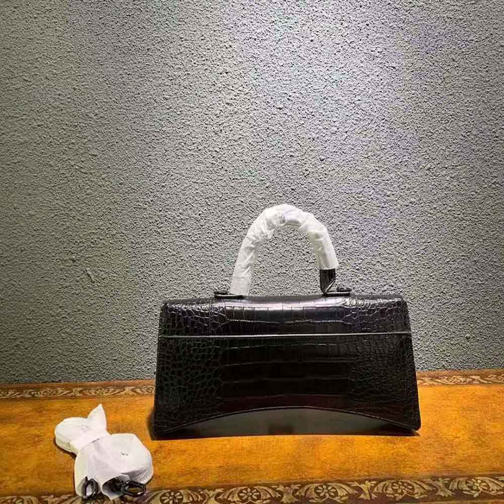 Side profile showing curved hourglass silhouette of Balenciaga Women Hourglass Stretched Top Handle Bag