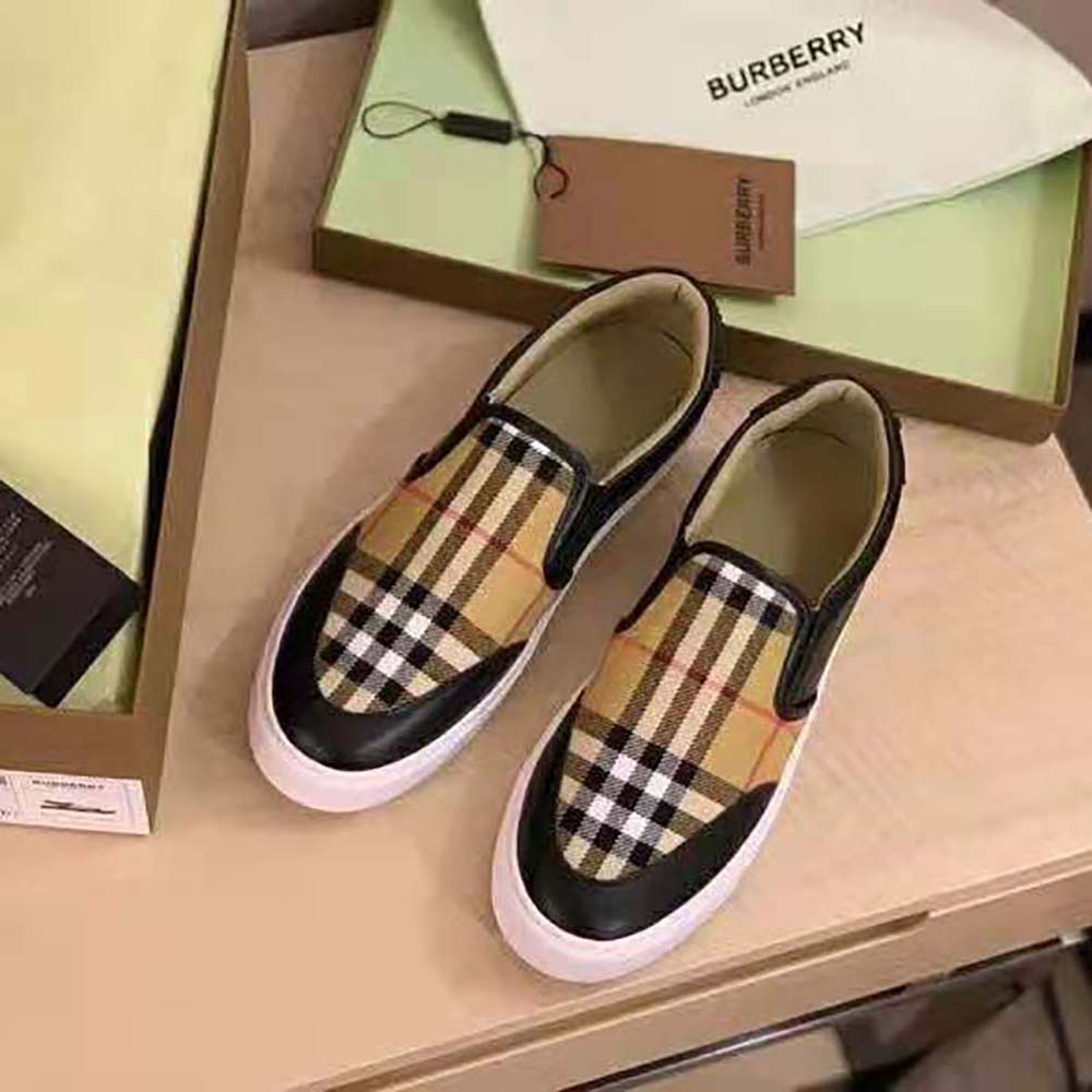 Side profile showing sleek black leather on Burberry Women slip-on sneakers