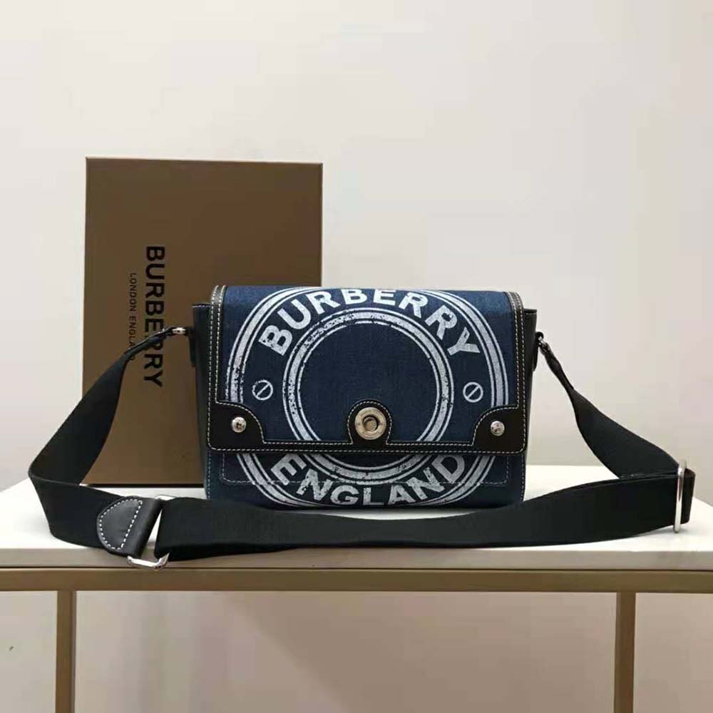 Close-up of Burberry logo hardware on denim crossbody bag