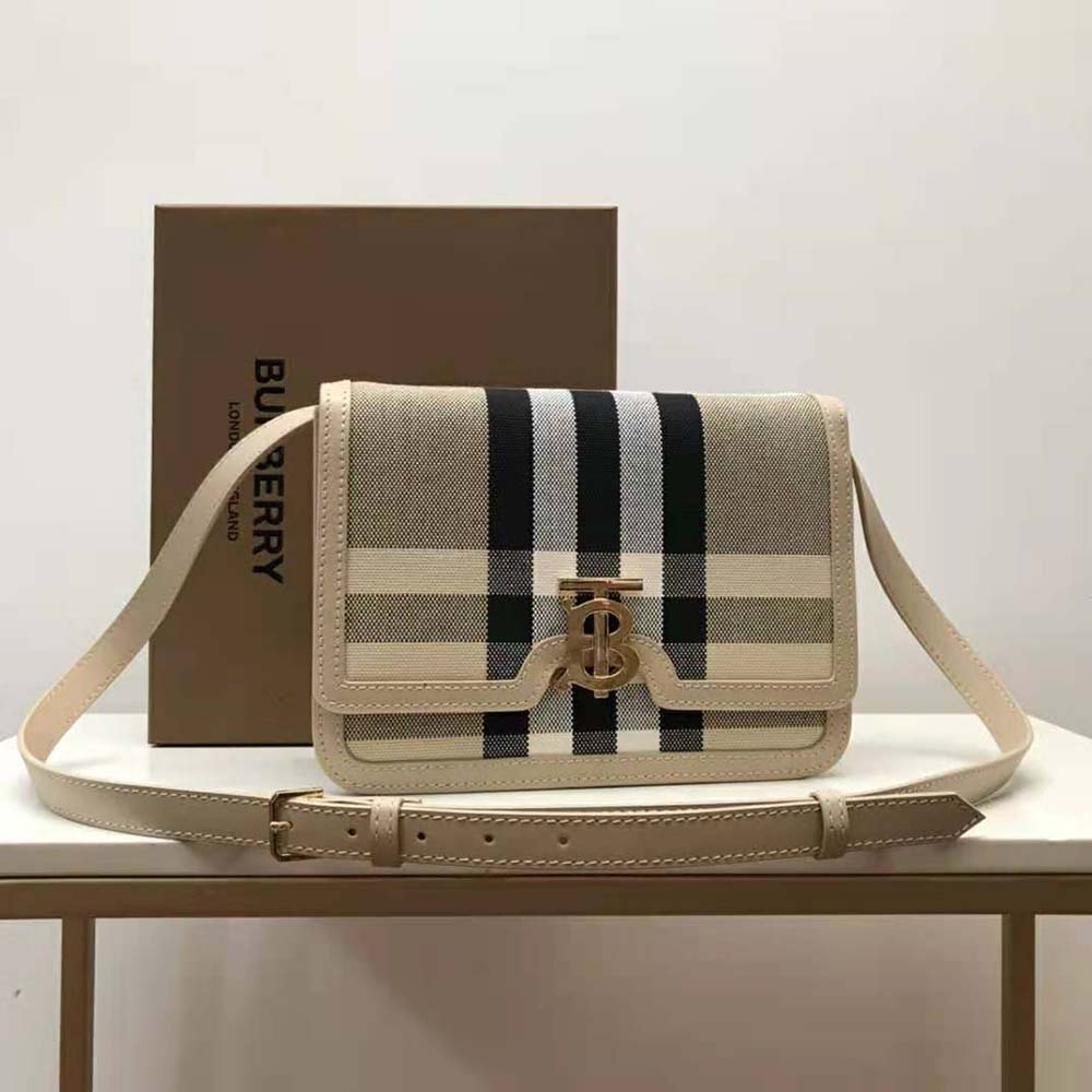 Close-up of gold-tone TB hardware on Burberry Women Medium Check Canvas and Leather TB Bag-Beige