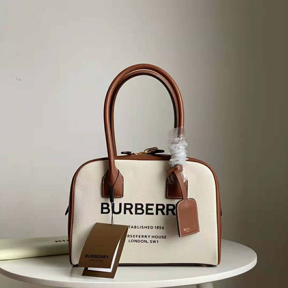 Close-up of gold-tone hardware on Burberry Women Medium Horseferry Print Cotton Canvas Half Cube Bag-Brown