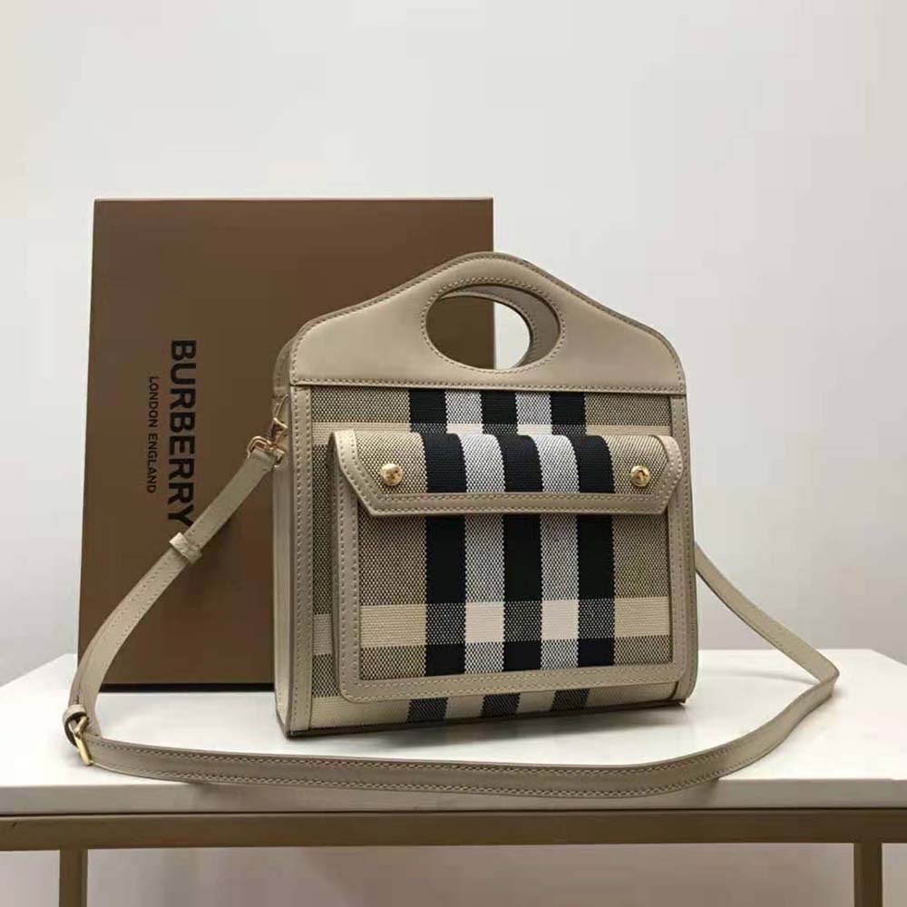 Close-up of beige check canvas and leather trim on Burberry bag