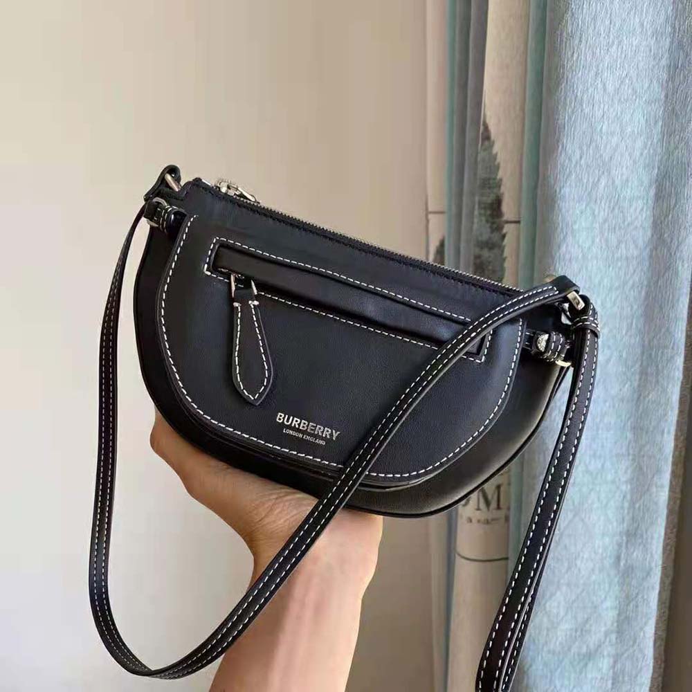 Side profile showing silhouette of Burberry Women Mini Leather Double Olympia Bag-Black