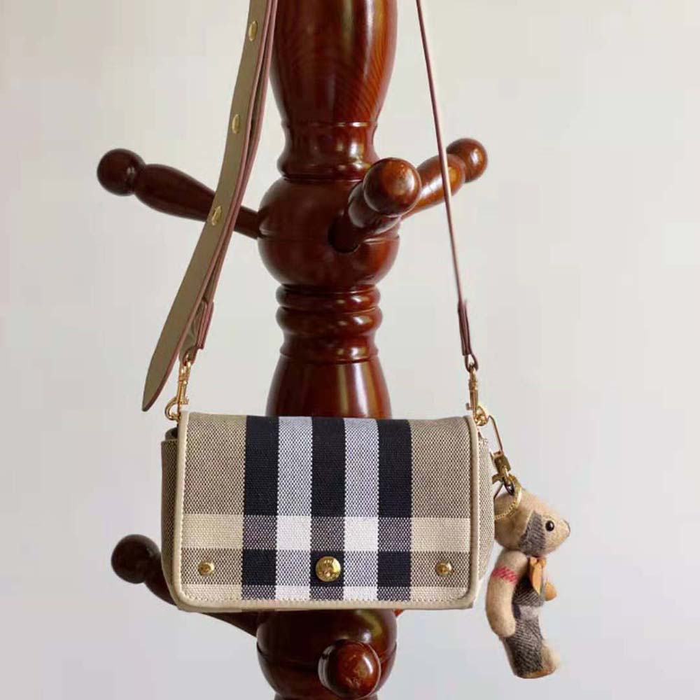 Side angle showing adjustable strap on Burberry crossbody bag