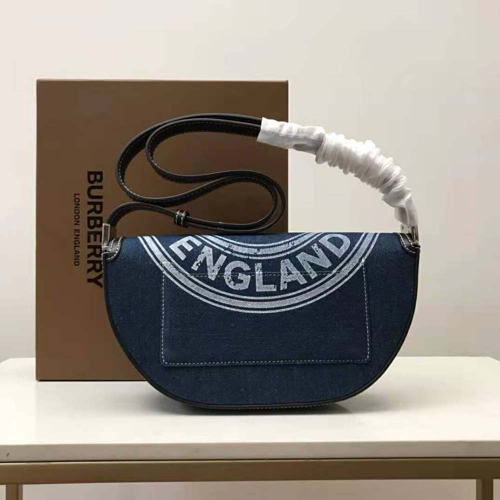 Side angle showing denim and leather texture of Burberry Olympia Bag