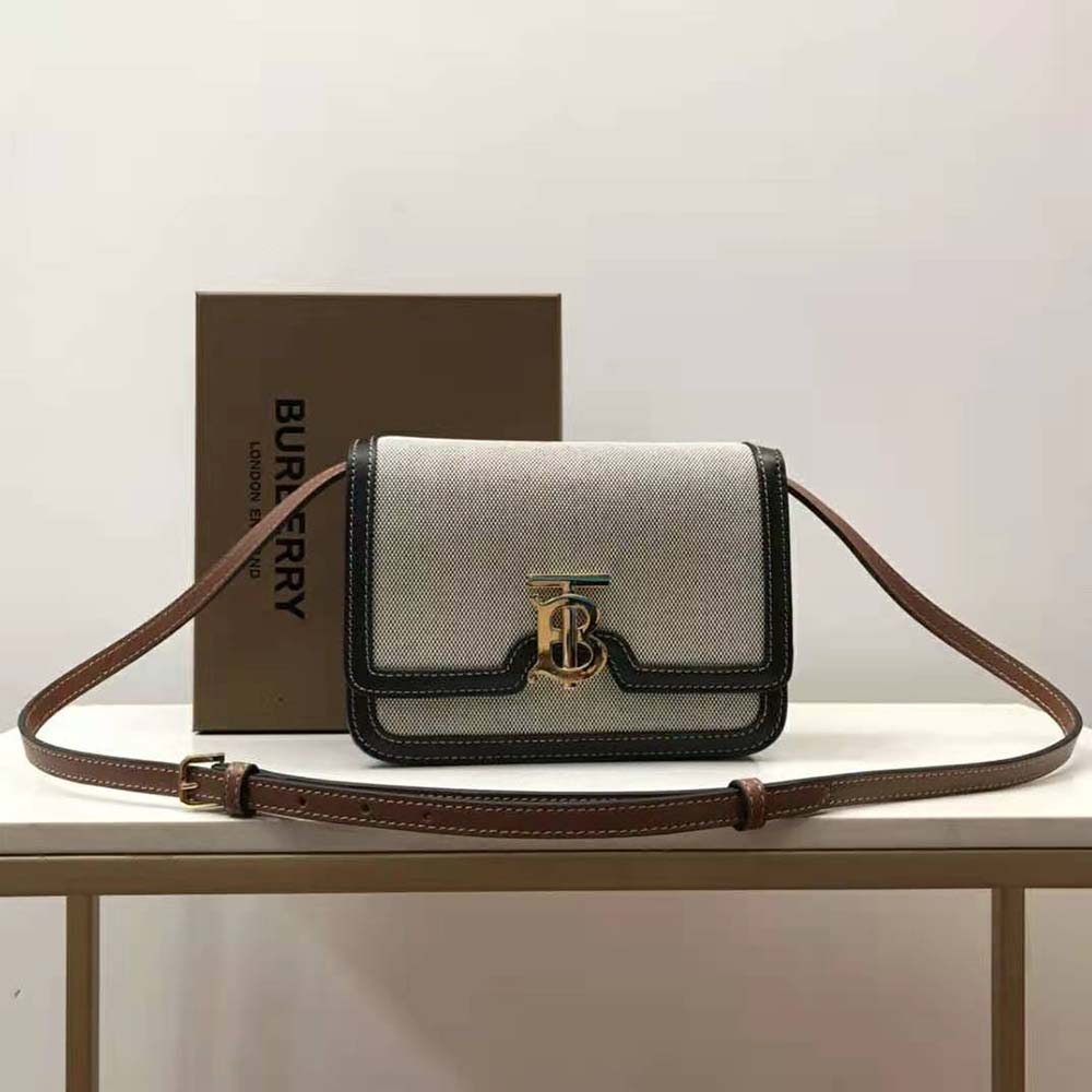 Close-up of gold TB clasp on Burberry Small Tri-tone Canvas and Leather Bag
