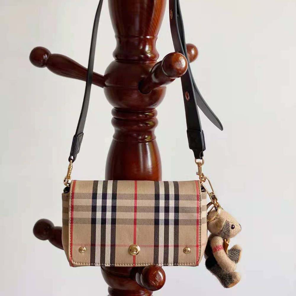 Close-up of vintage check pattern and leather trim on Burberry crossbody bag