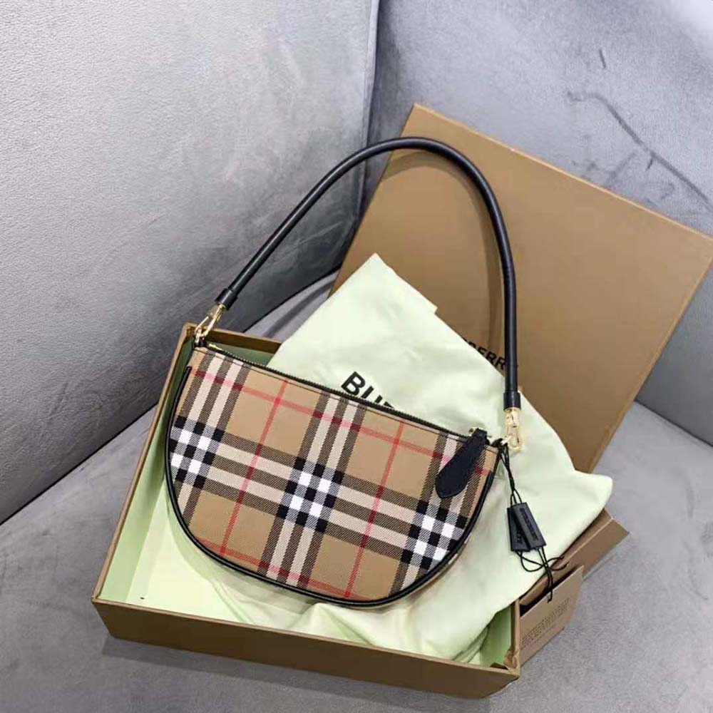 Close-up of gold-tone zipper and vintage check fabric on pouch