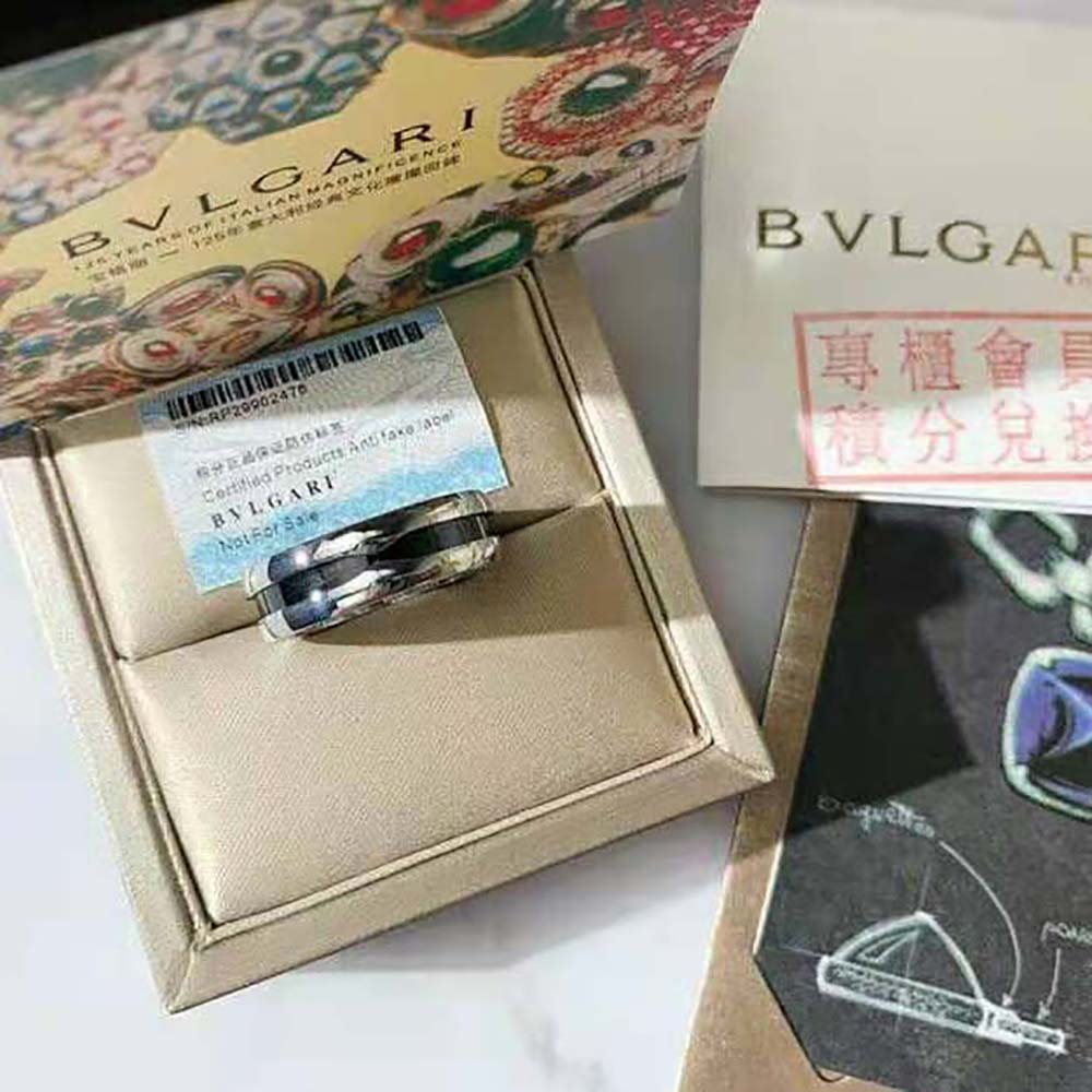 Close-up detail of engraved Bvlgari logo on the black ceramic band ring