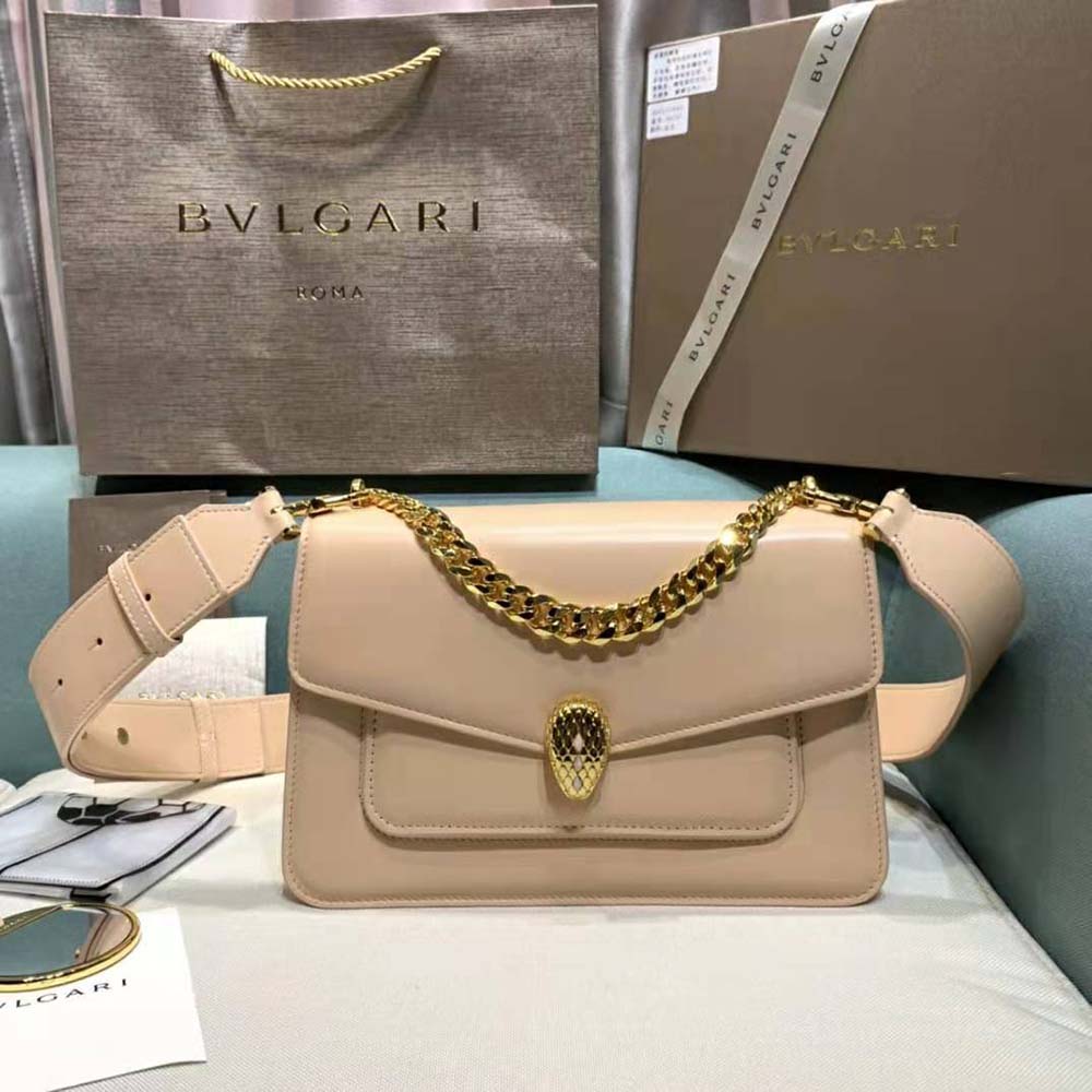 Close-up on gold serpenti snakehead clasp of Bvlgari crossbody bag