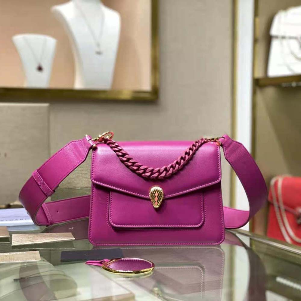 Close-up of signature serpent head clasp on purple Bvlgari crossbody bag