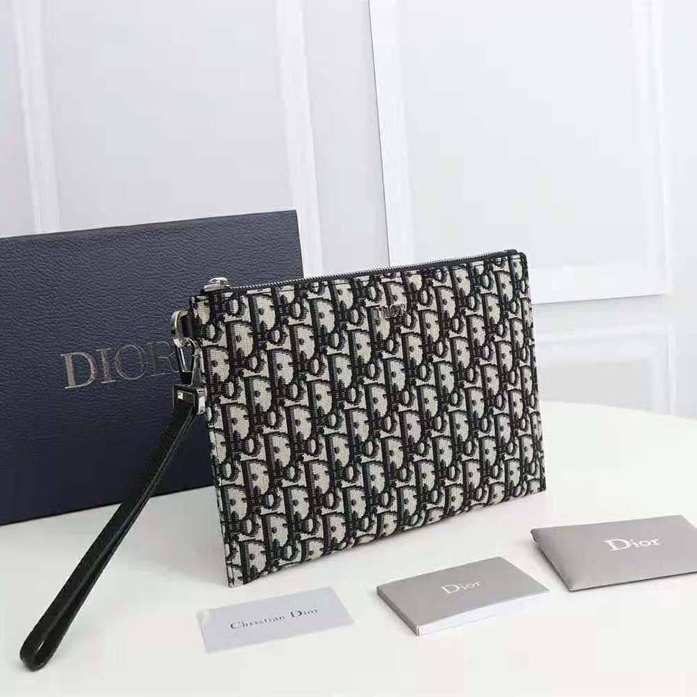 Side angle showing silver zip and slim profile of Dior Men A4 Pouch