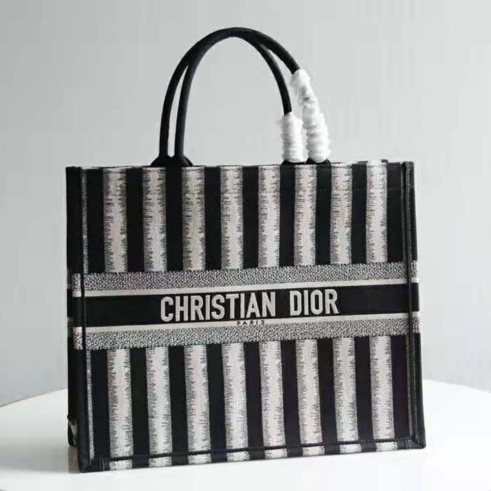 Close-up on blue D-stripes embroidery detail of Dior Book Tote