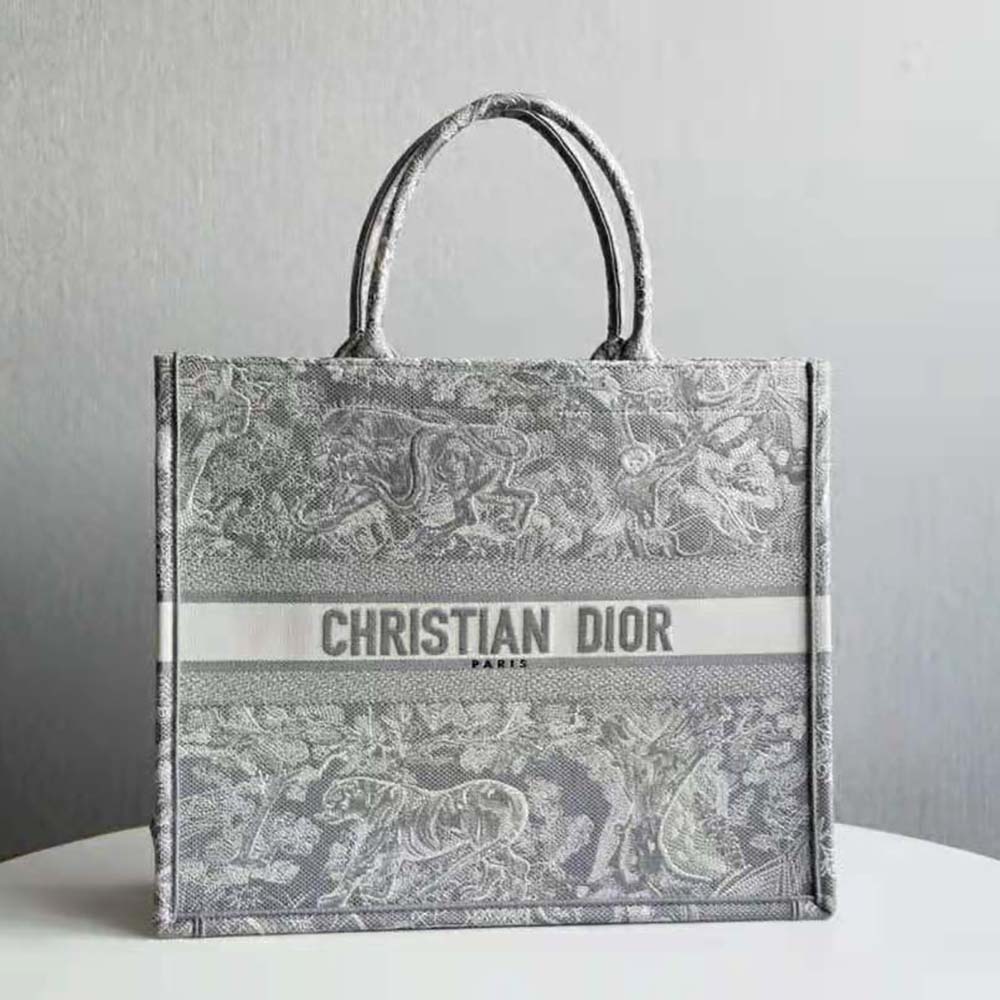 Close-up detail of reverse embroidery and silver hardware on Dior Book Tote