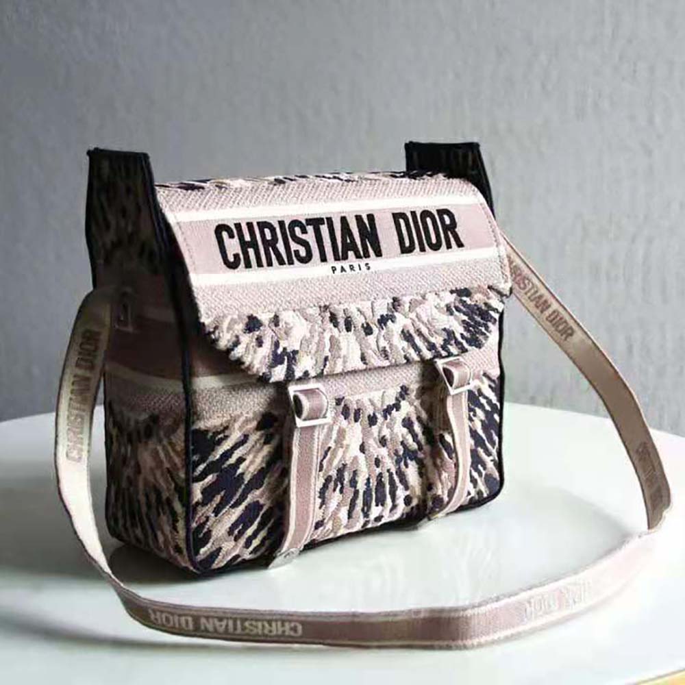 Side angle showing silver hardware and adjustable straps of Dior Women Diorcamp Bag