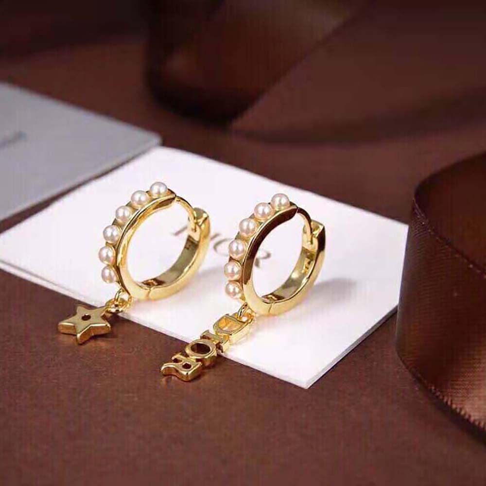 Detailed shot of gold-finish metal and stud closure on Dior Women Dio(r)evolution Earrings