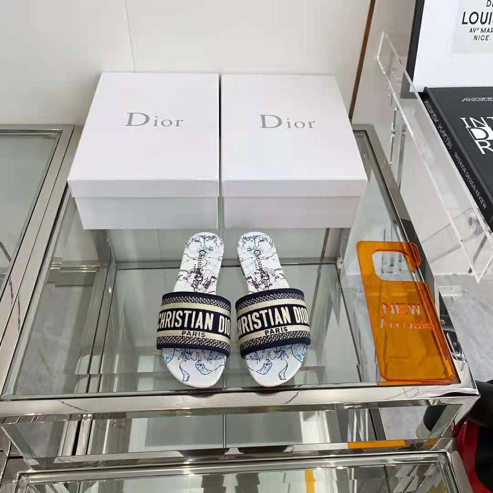 Close-up of blue embroidered cotton and Dior signature on slide