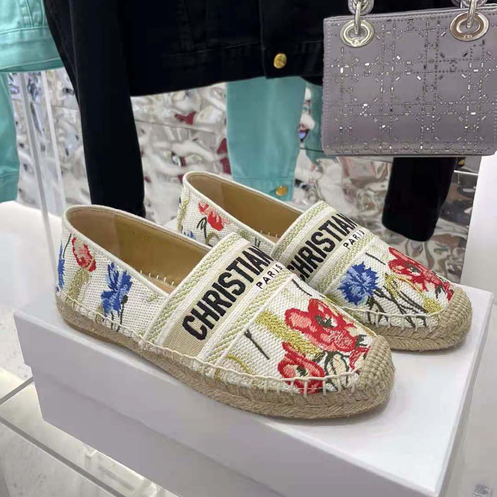 Close-up of Dior hibiscus embroidery on beige cotton espadrille upper
