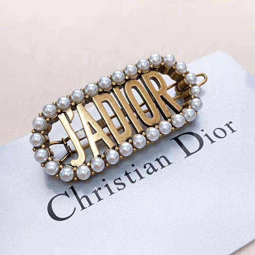 Top angle showing intricate J’Adior signature on antique gold barrette
