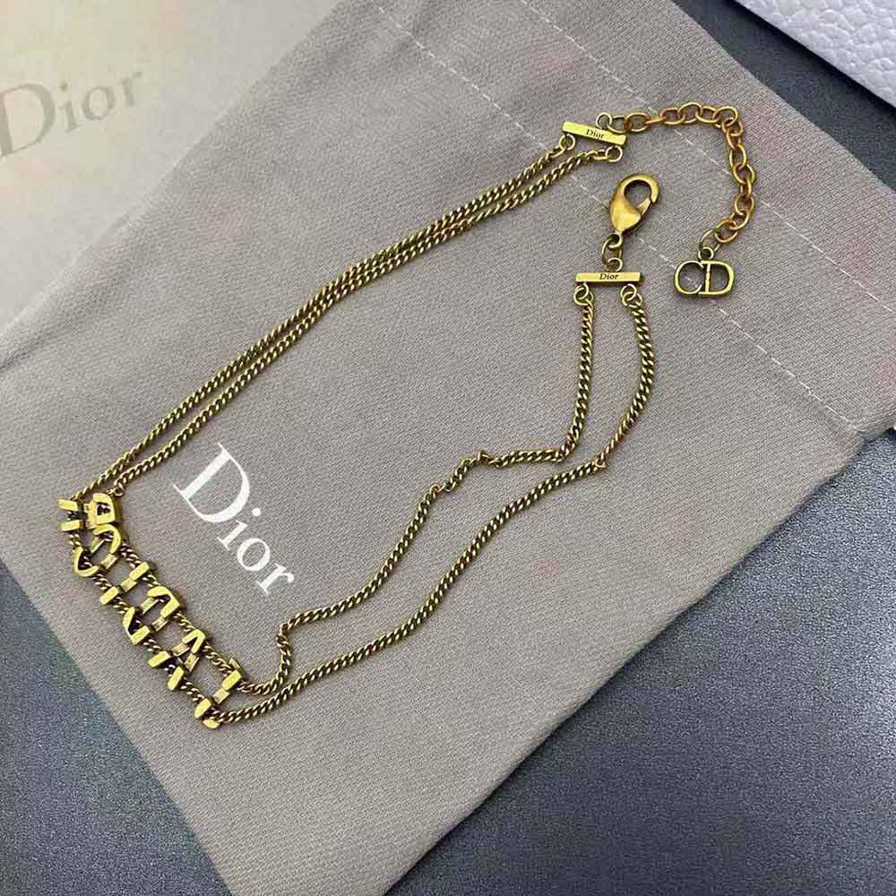 Side angle highlighting signature ‘J’Adior’ detail on gold choker
