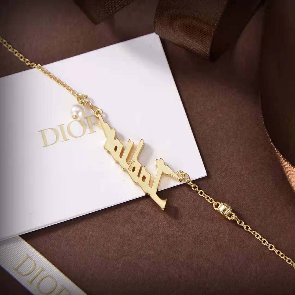 Model wearing Dior Women J’Adior Necklace Gold-Finish Metal with elegant outfit