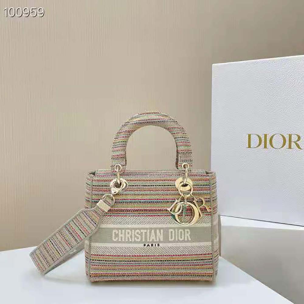 Close-up of embroidered stripes and silver 'D' hardware on Dior Lady D-lite Bag